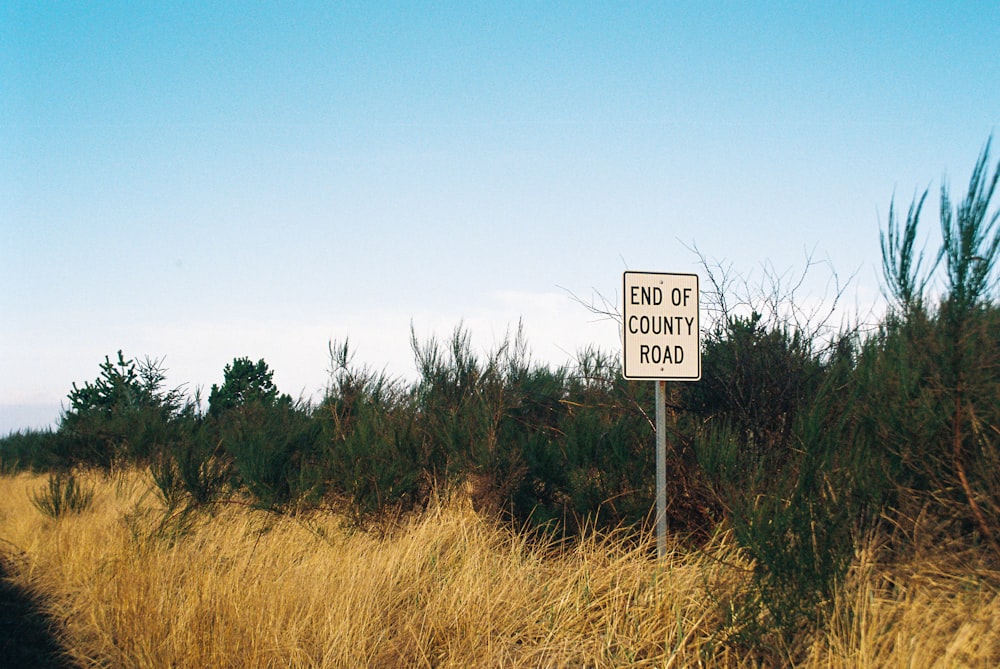 a sign that is in the middle of a field