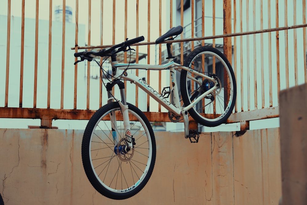 a bicycle hanging from the side of a building