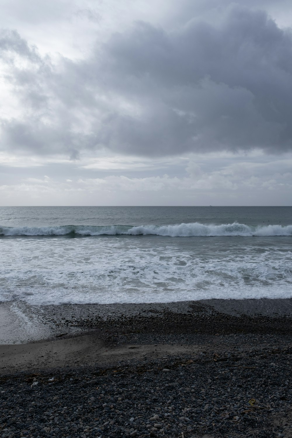 a person walking on a beach near the ocean