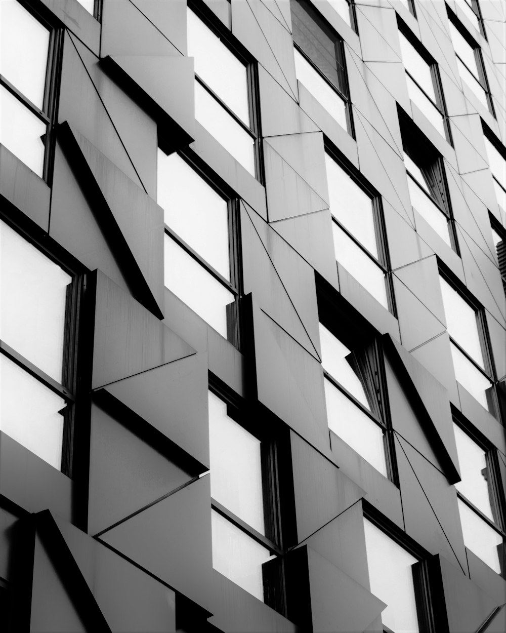 a black and white photo of a building with many windows