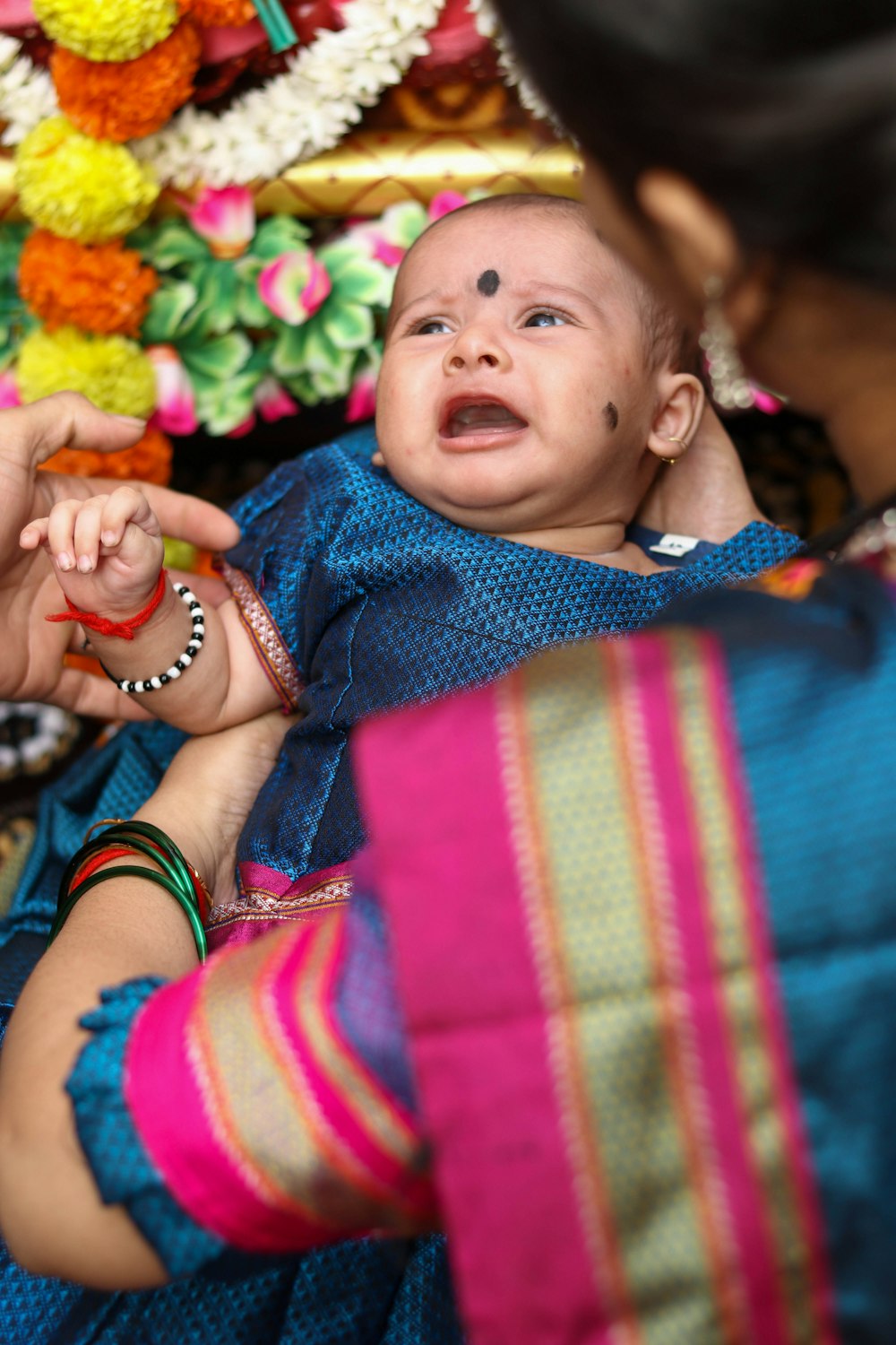 a woman holding a baby in her arms