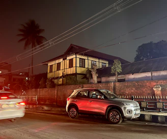 Nighttime scene of a house powered by an electric vehicle through bidirectional charging.