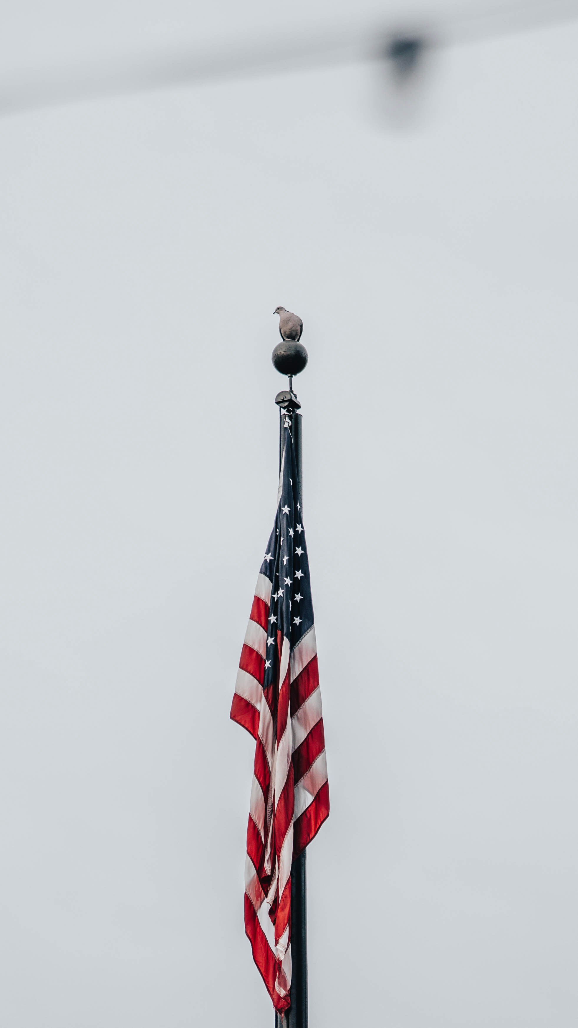 an american flag on top of a flag pole