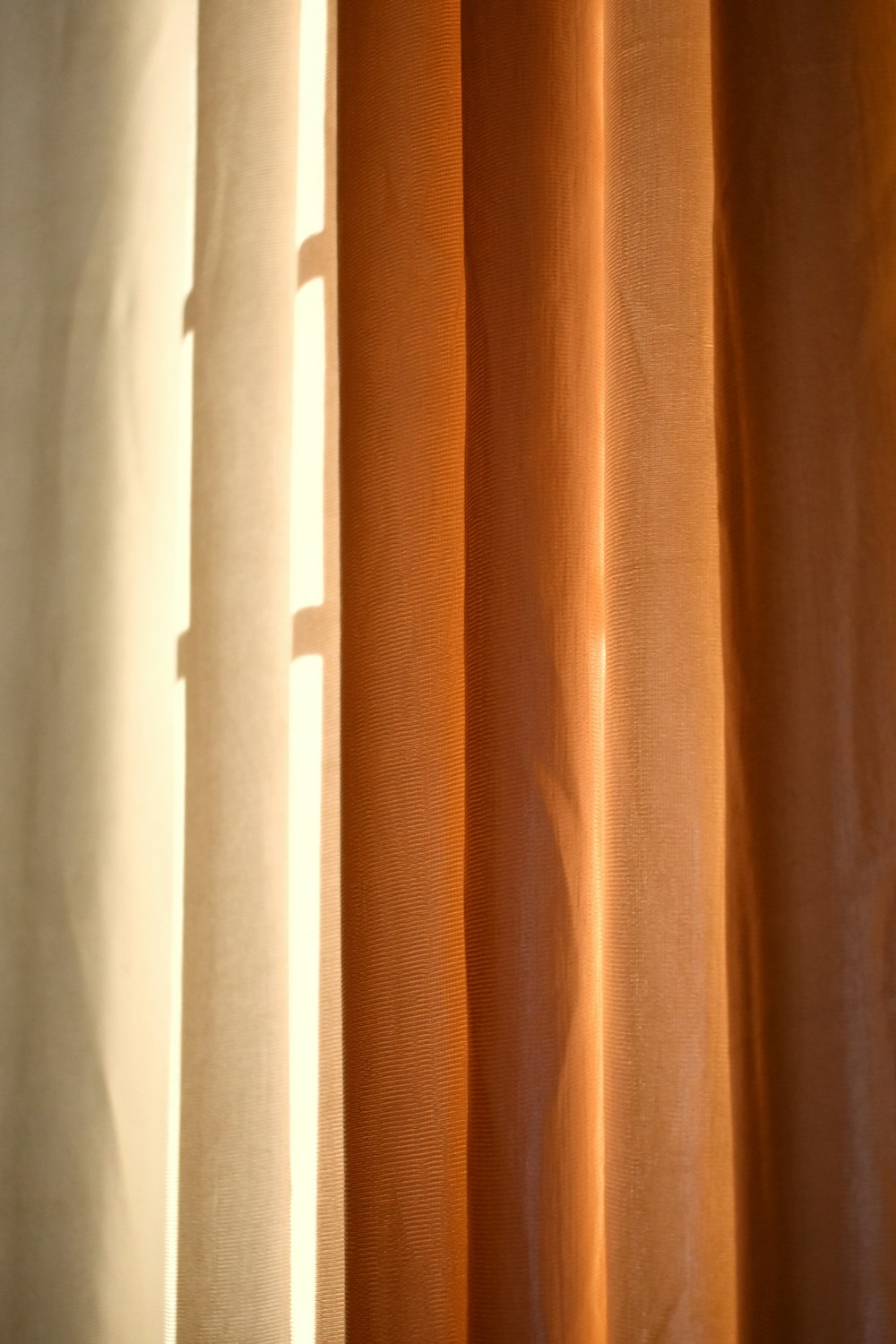 a close up of a curtain with light coming through it