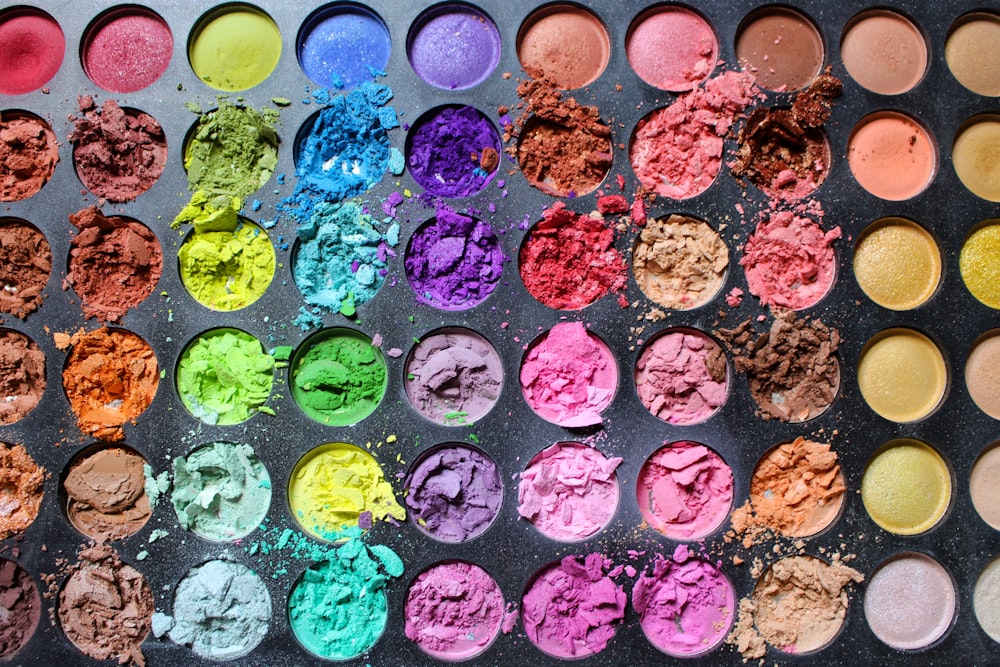 a palette of different colored powders on a table