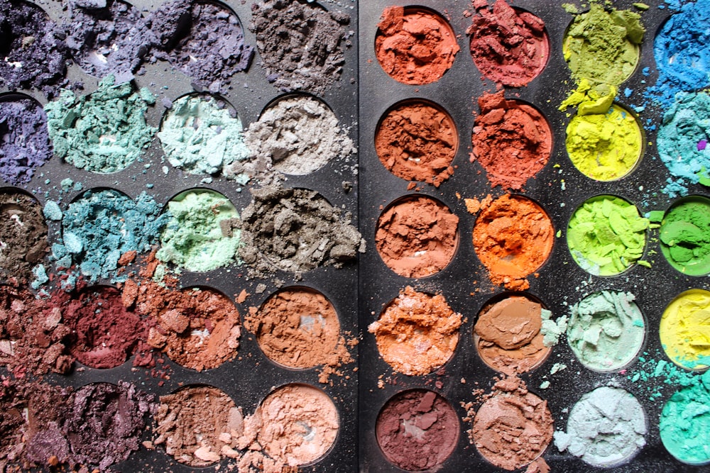 a pan filled with lots of different colored powders