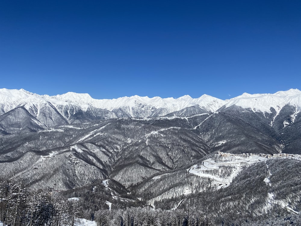 a view of a snowy mountain range from a ski slope