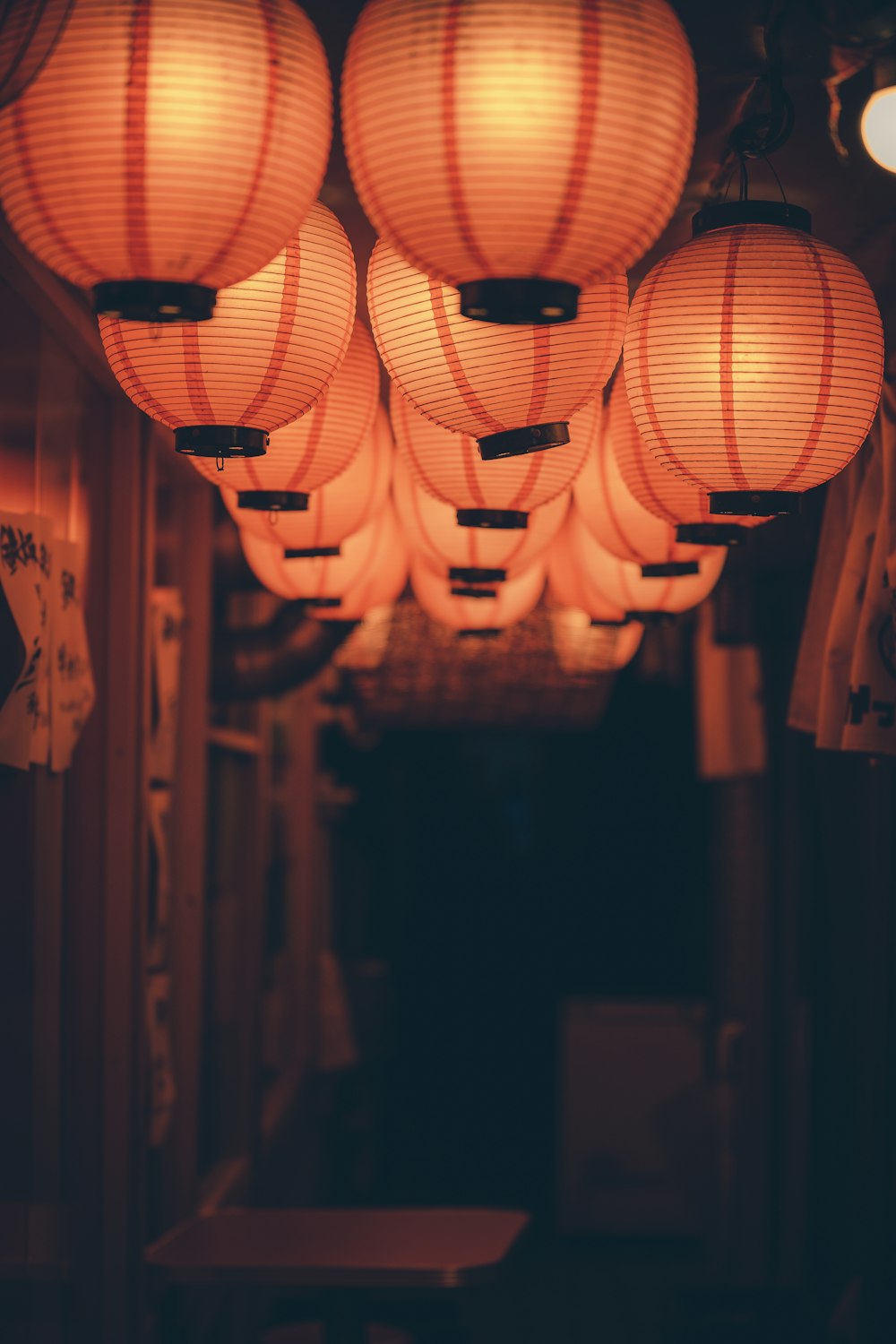 a group of paper lanterns hanging from a ceiling