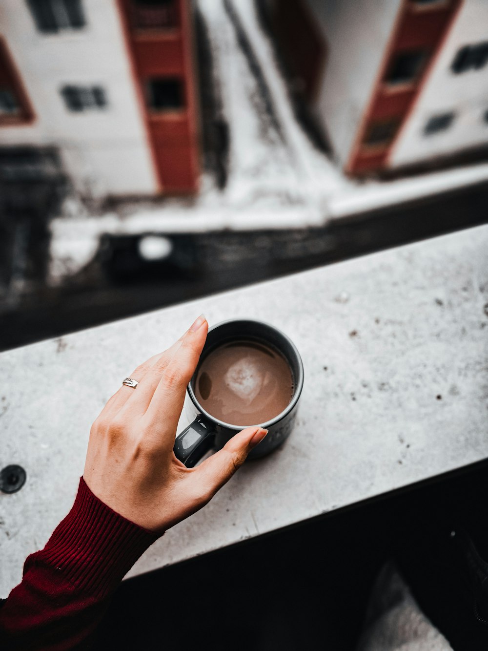 a person is holding a cup of coffee