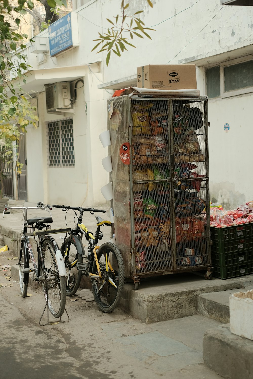 two bicycles parked next to a cart full of food