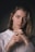 a woman in a white sweater posing for a picture