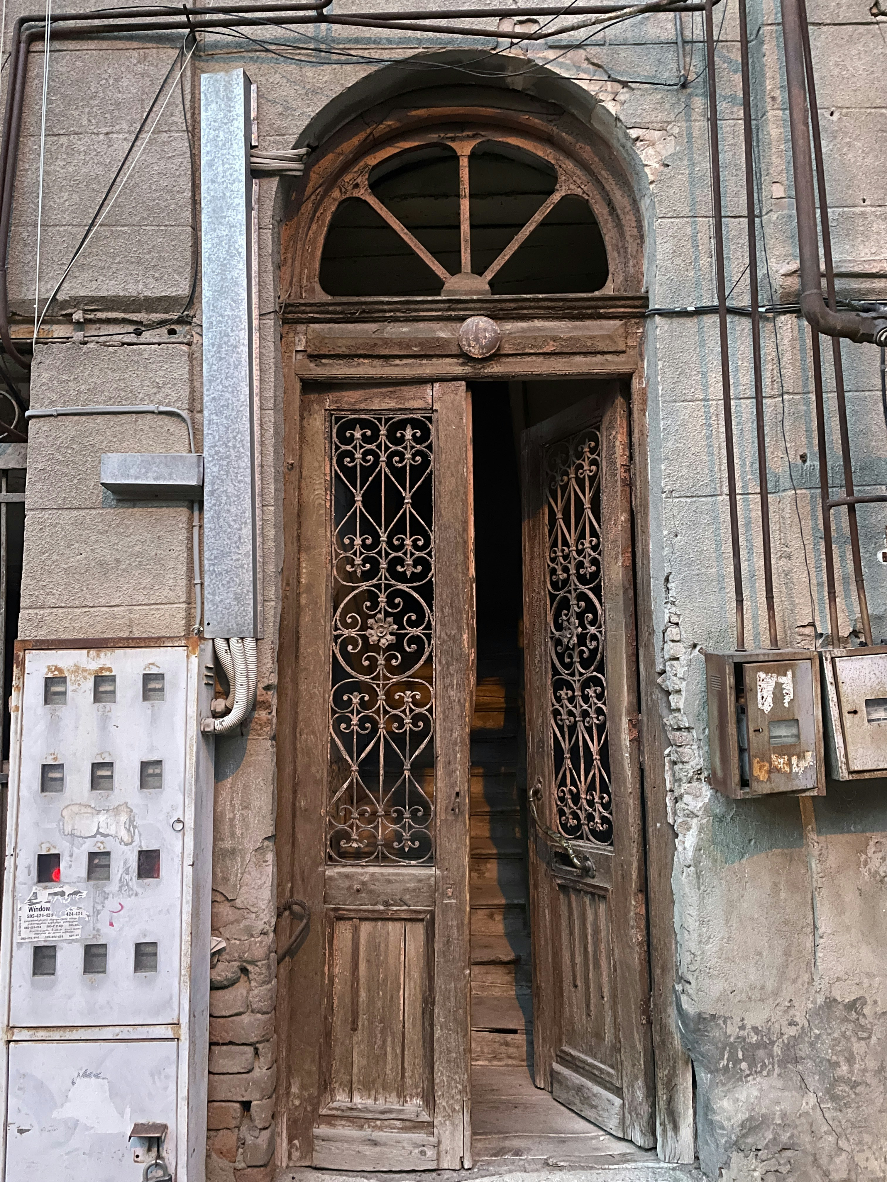 an old building with two doors and a window