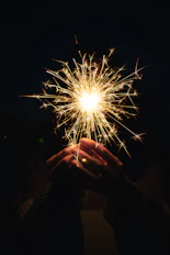 a person holding a sparkler in their hands