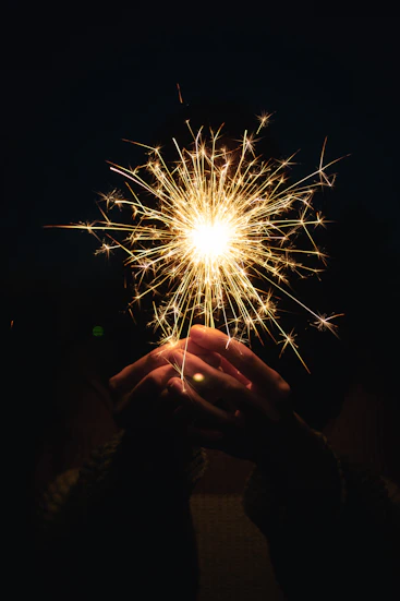 a person holding a sparkler in their hands