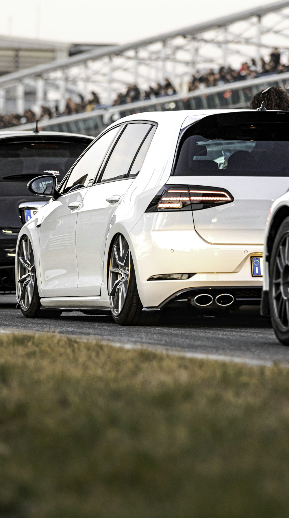 a group of cars driving down a race track