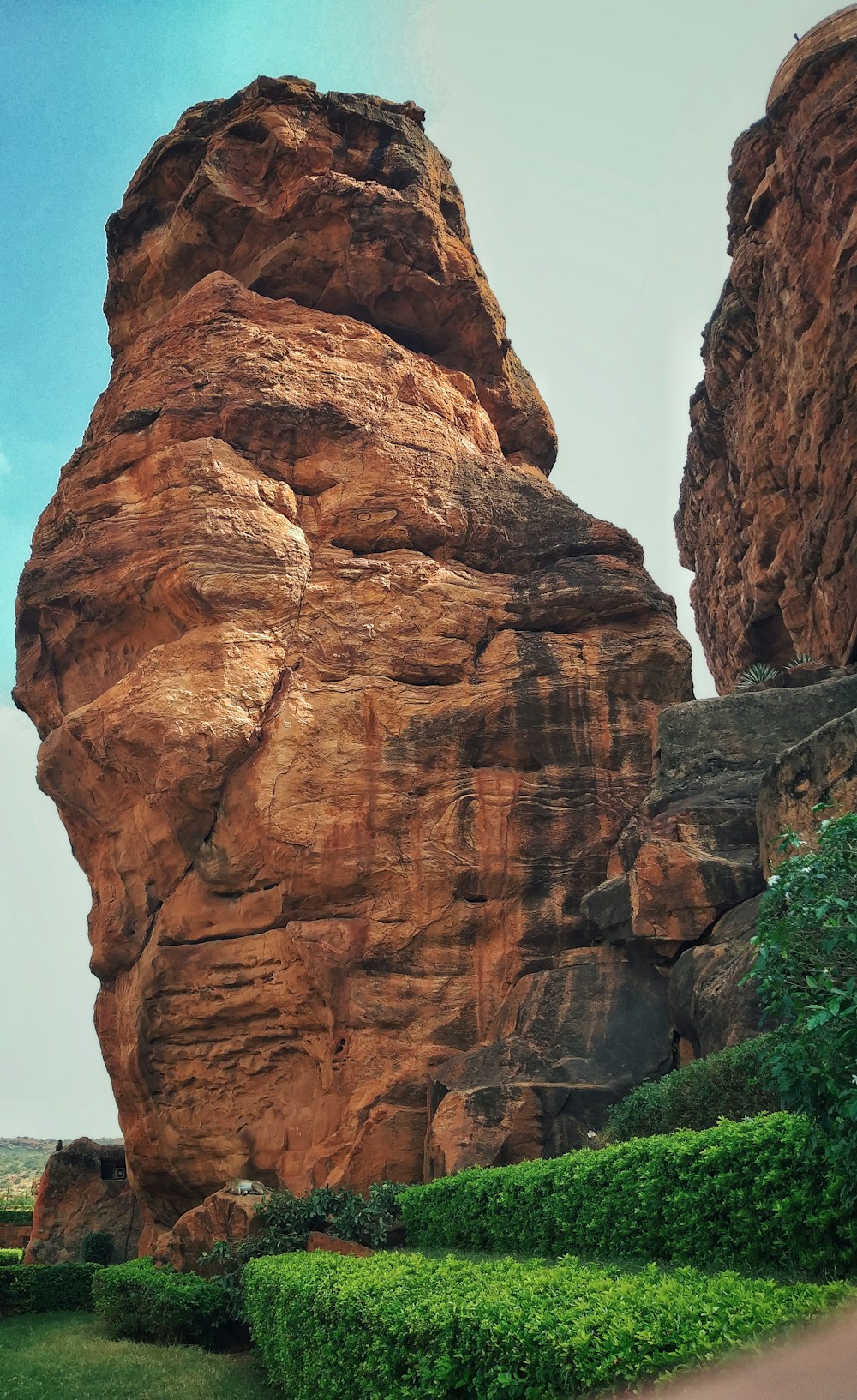 a large rock formation in the middle of a field