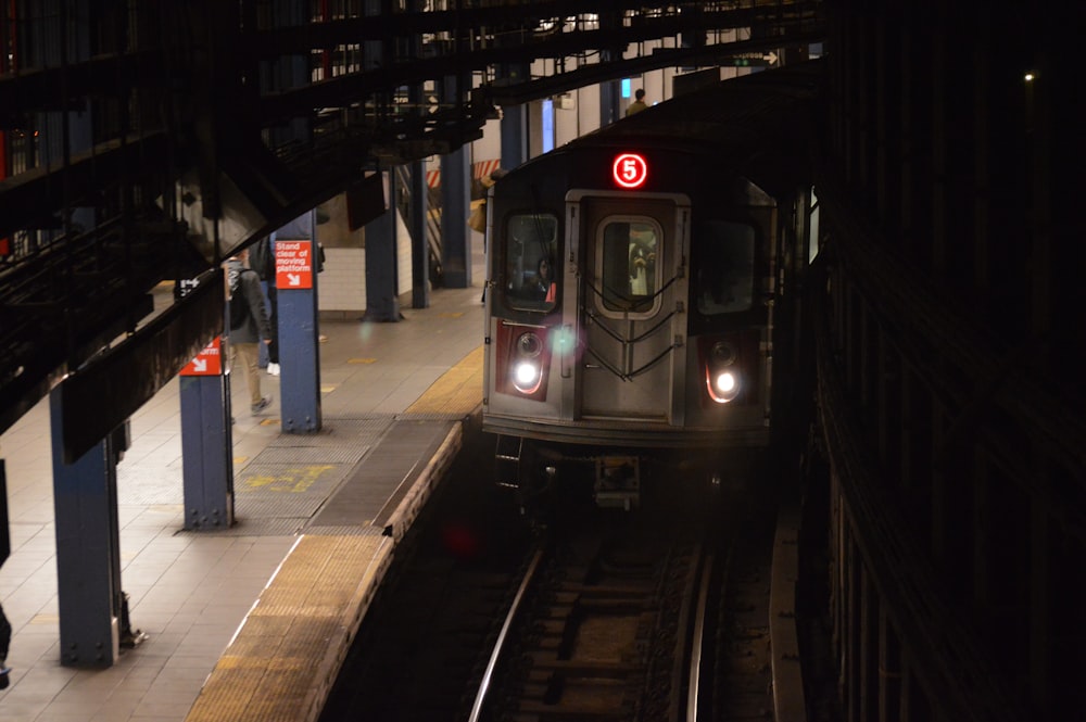 a train is coming down the tracks at night