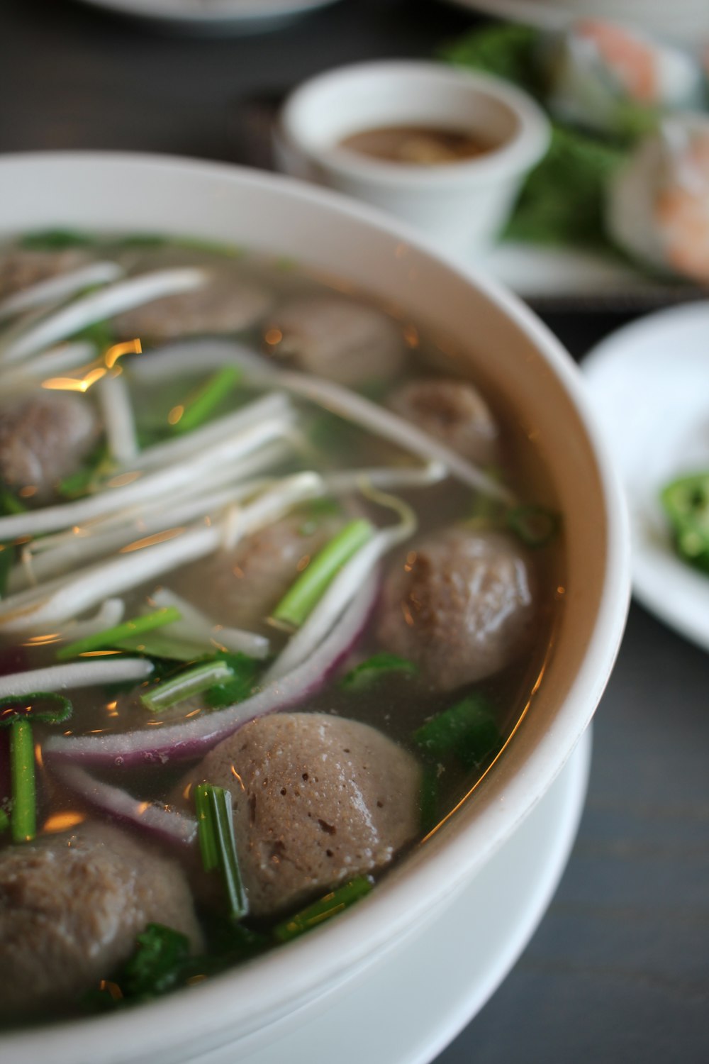 a bowl of soup with meatballs and vegetables