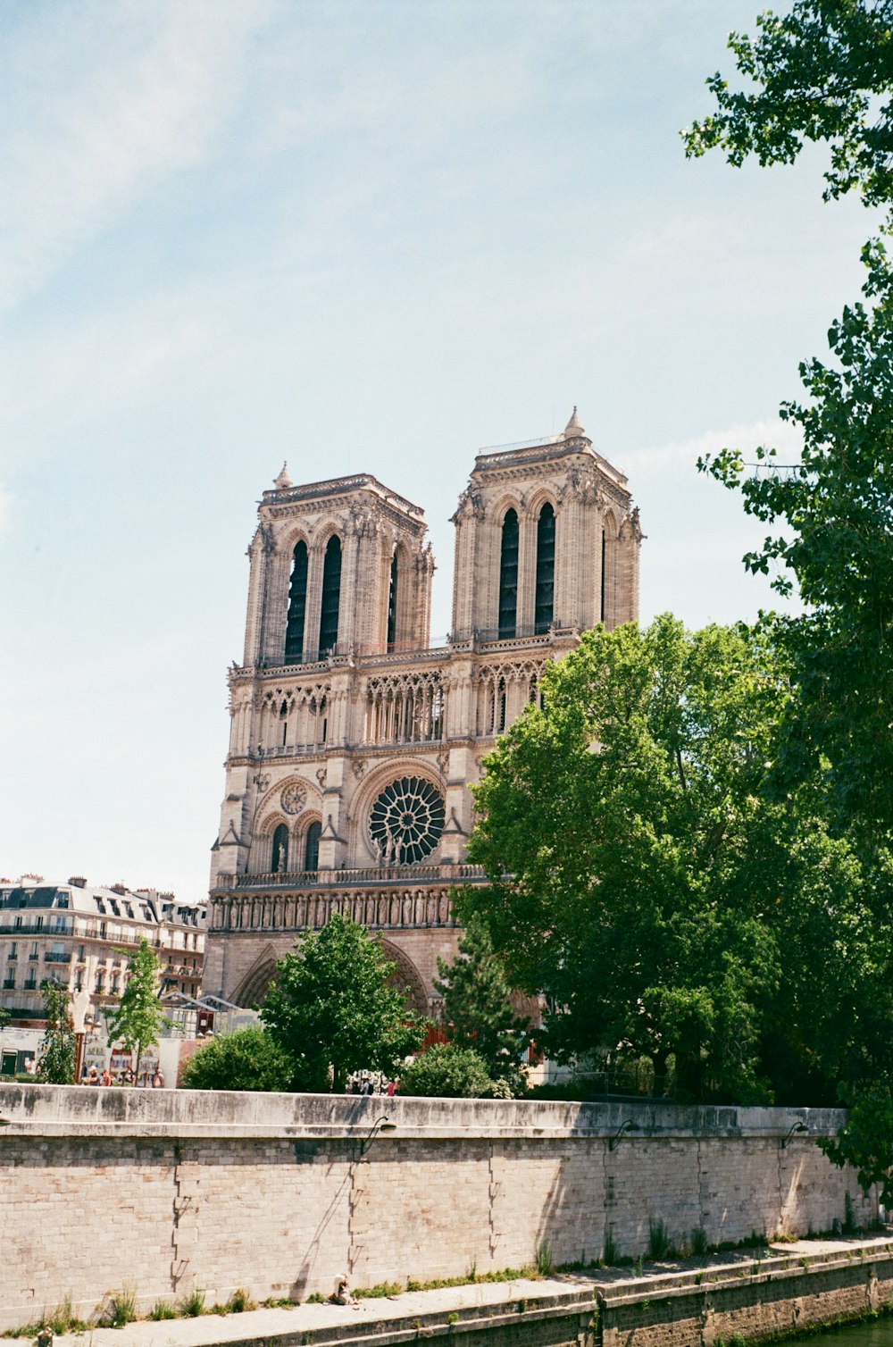 a large cathedral towering over a city next to a river