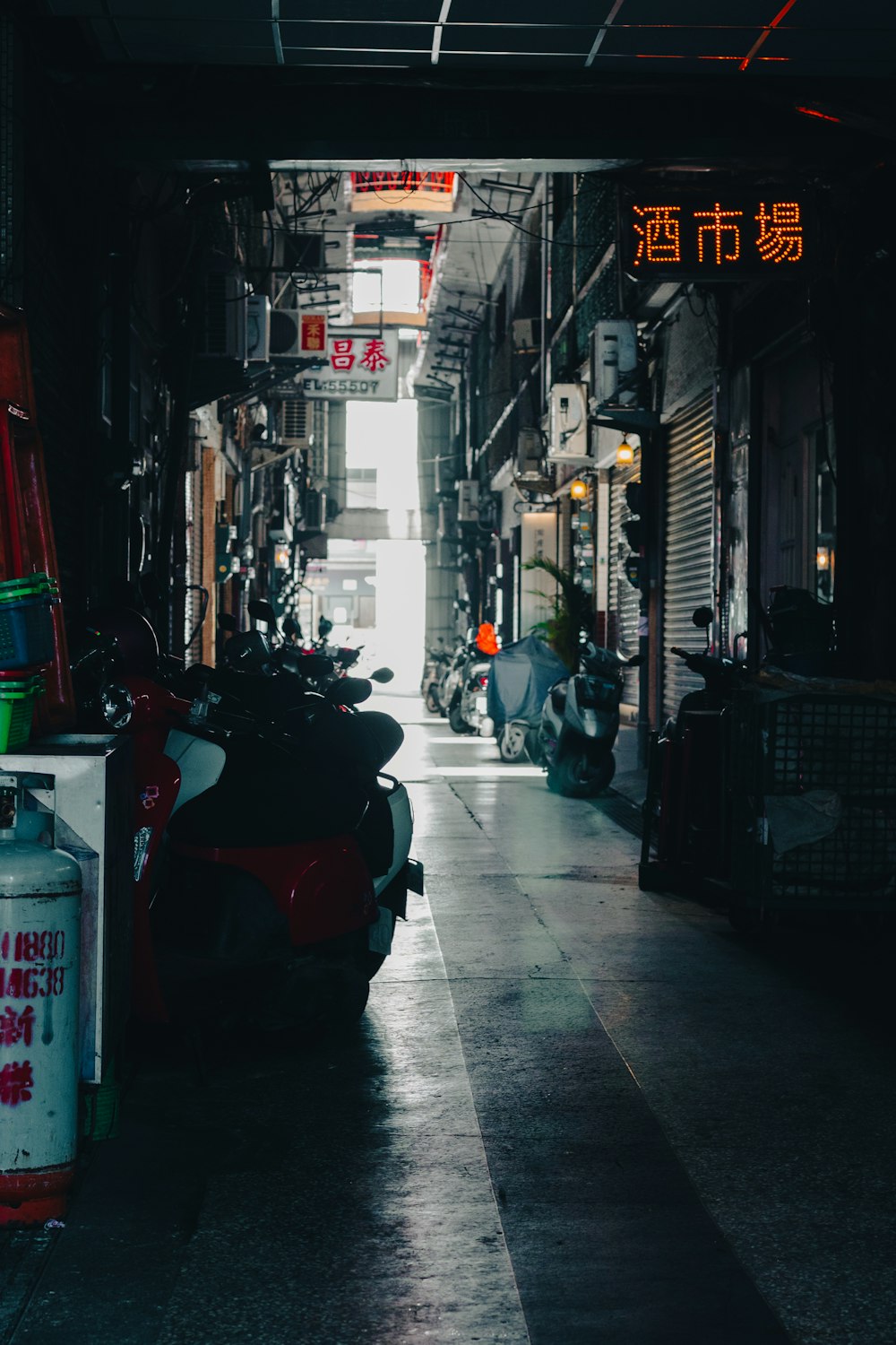 a motorcycle is parked in a narrow alley