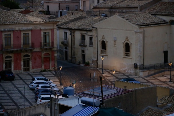 A charming old town square with cobblestone streets and historic architecture bathed in warm light.