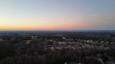 A panoramic view of a high-end residential neighborhood, captured in soft evening light.