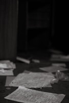 Wide angle view of an empty room with scattered papers and soft evening light.