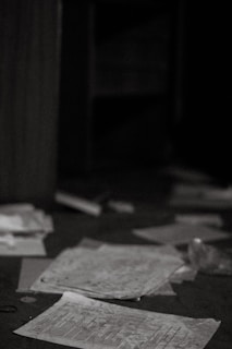 Wide angle view of an empty room with scattered papers and soft evening light.