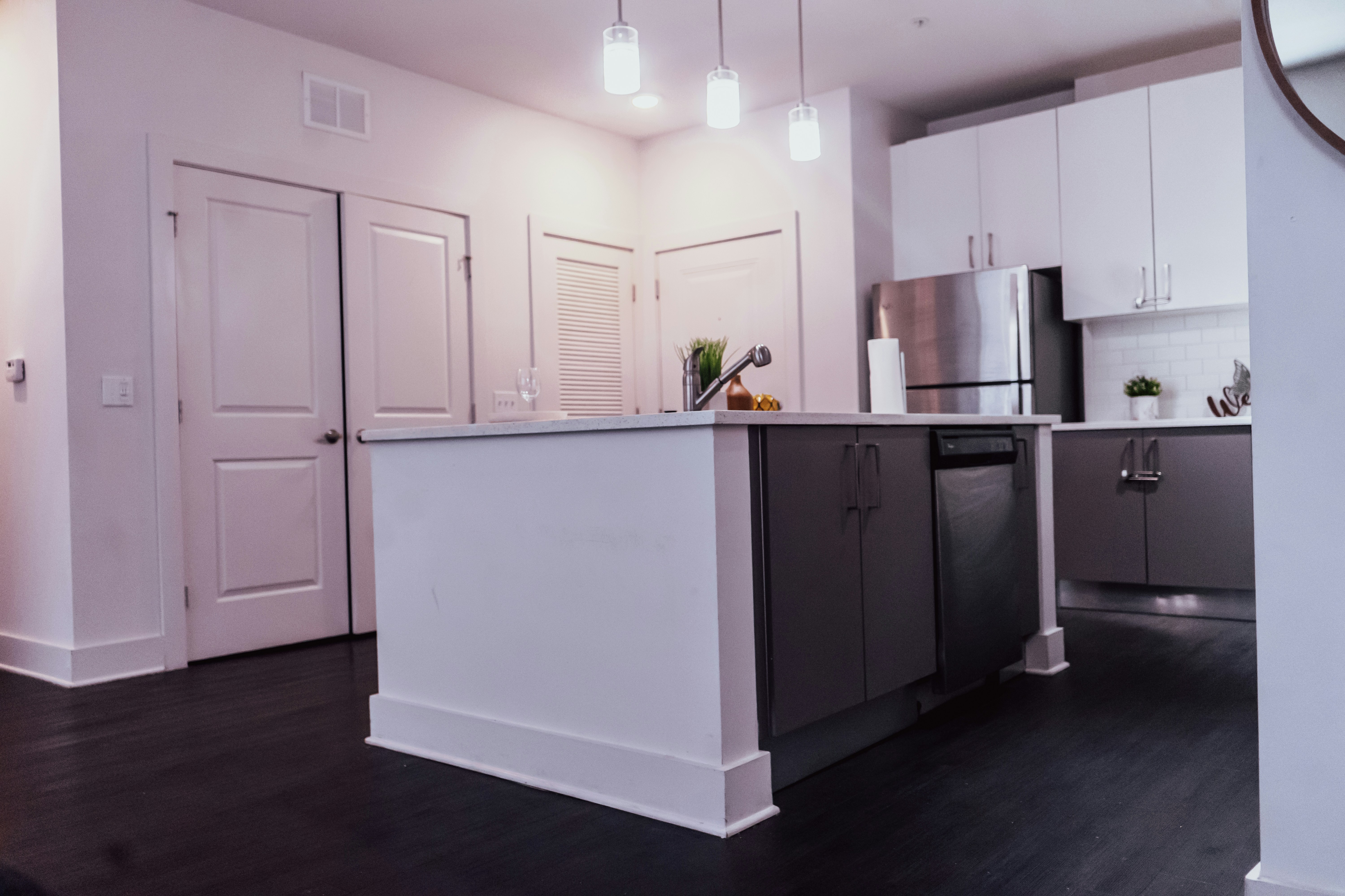 Kitchen renovation with white cabinets and black floors