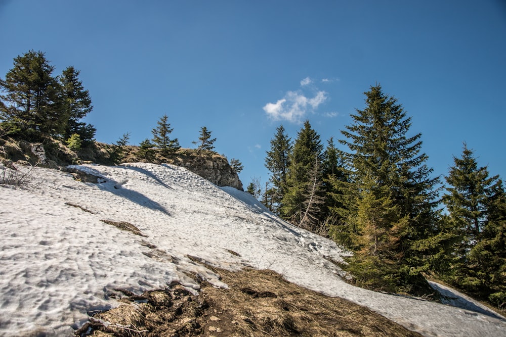 a man riding a snowboard down a snow covered slope