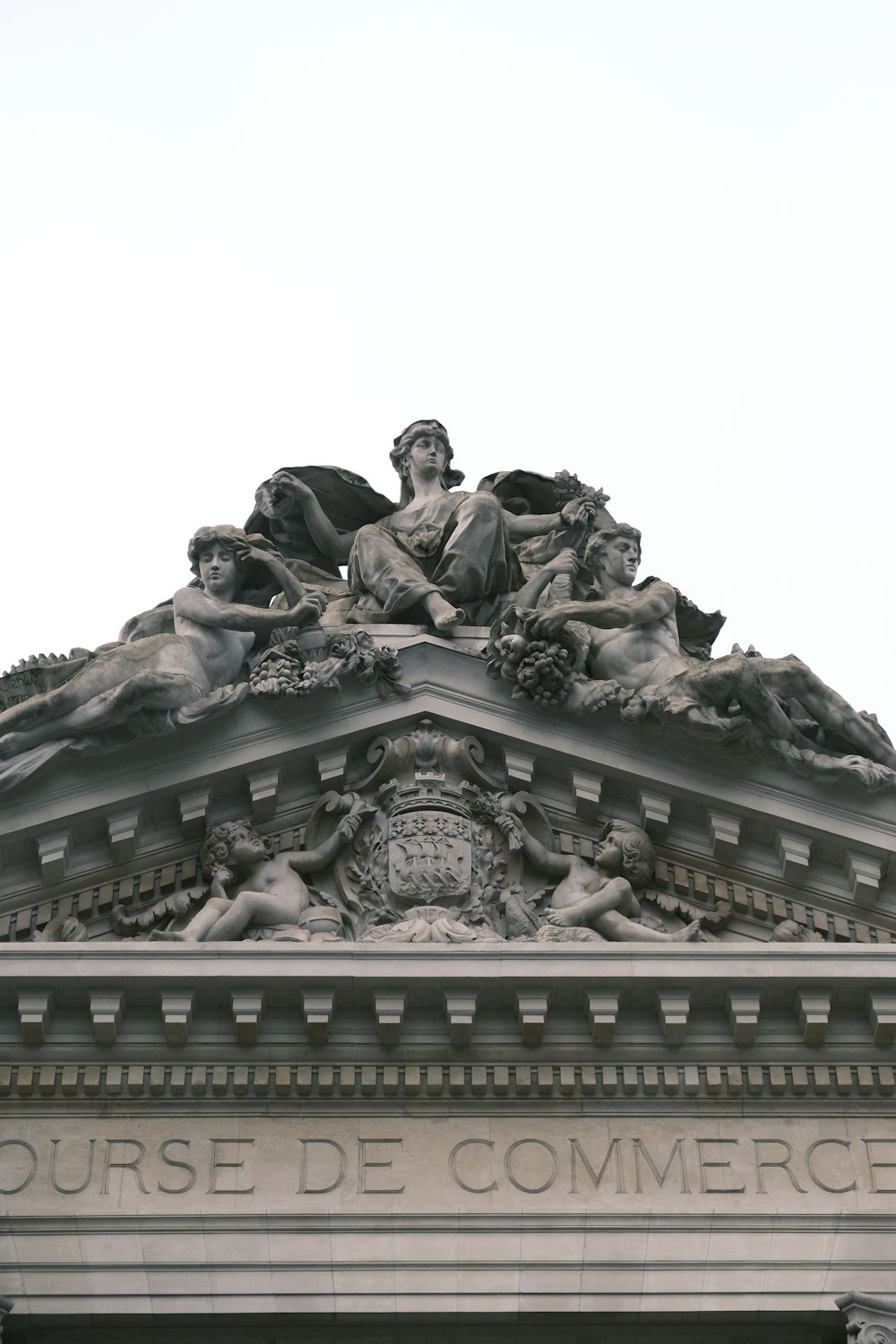 a statue on top of a building with a sky background