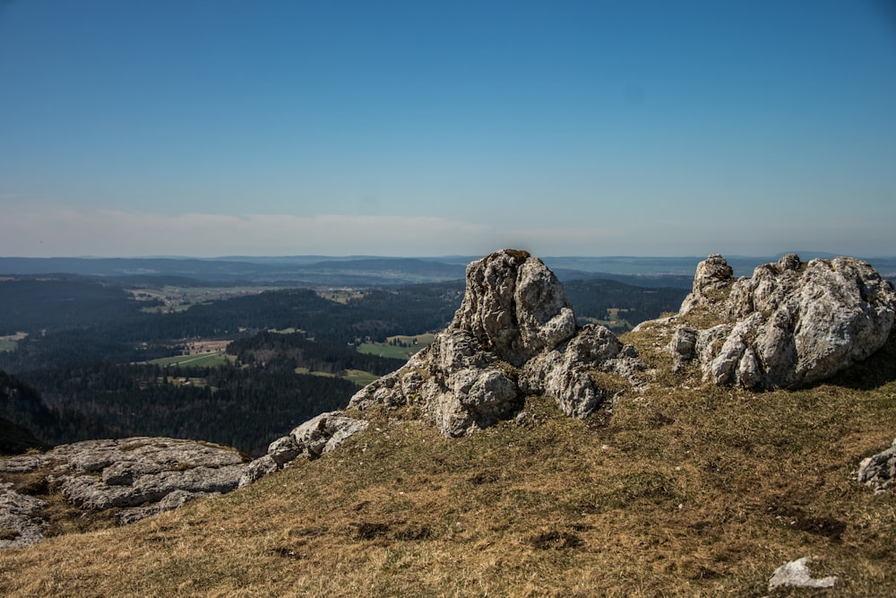 a rocky outcropping with a view of the valley below