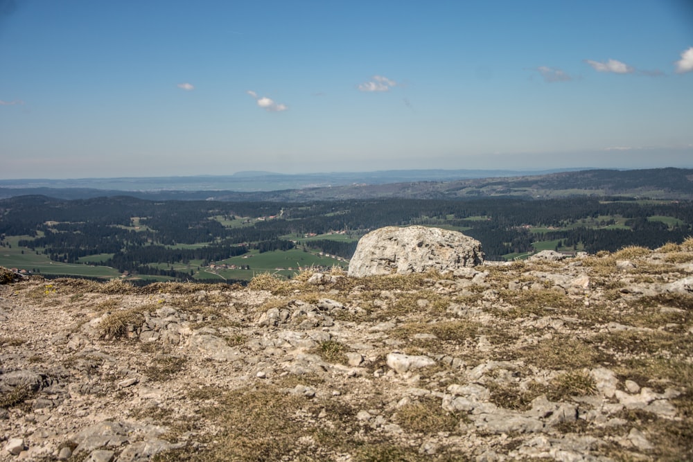 a rocky outcropping with a view of a valley