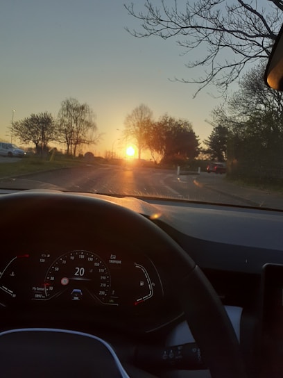 A warm sunset view of a comfortable car winding through a scenic Indian heritage route.