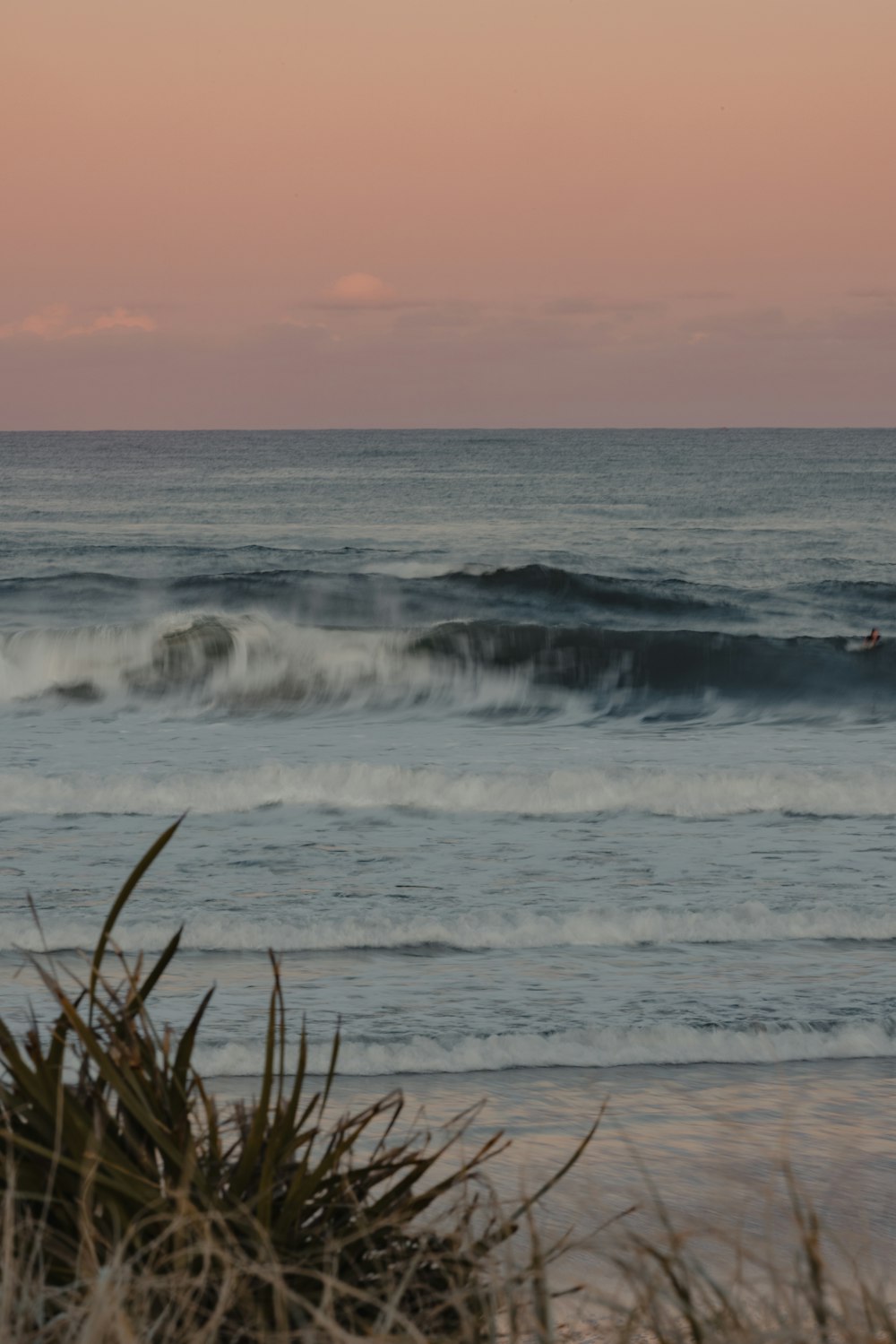 a person riding a surfboard on a wave in the ocean