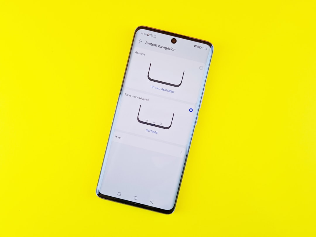 a cell phone sitting on top of a yellow surface,