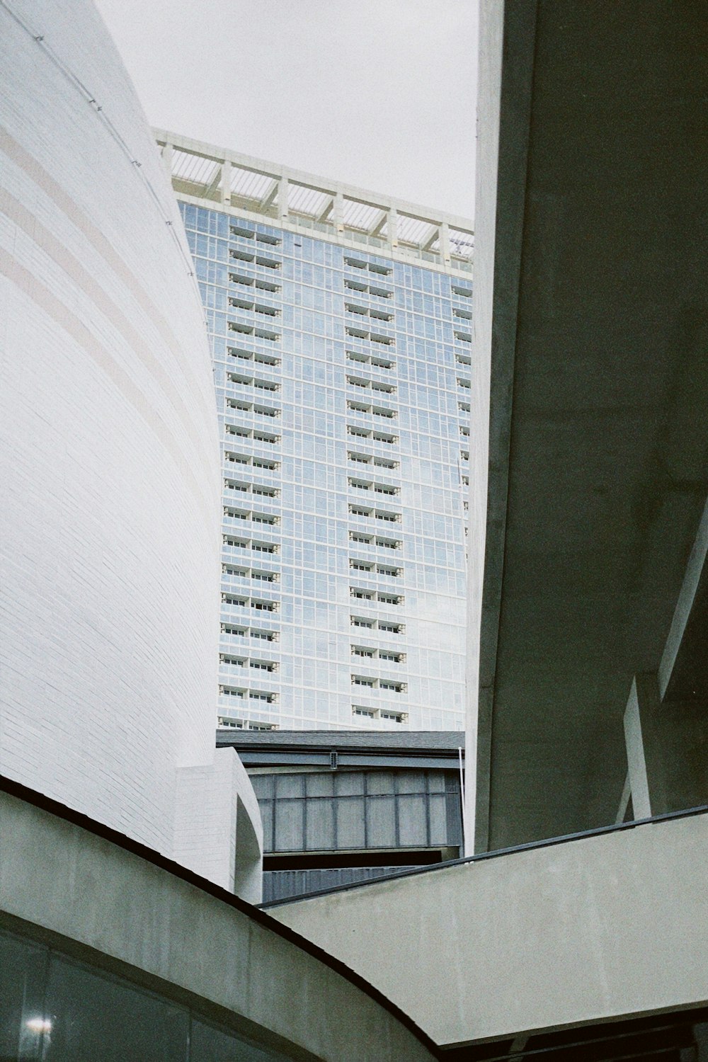 a tall white building sitting next to a tall white building