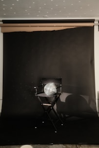 A cinematic film set with dramatic lighting and a director’s chair branded with brakadoom’s logo.