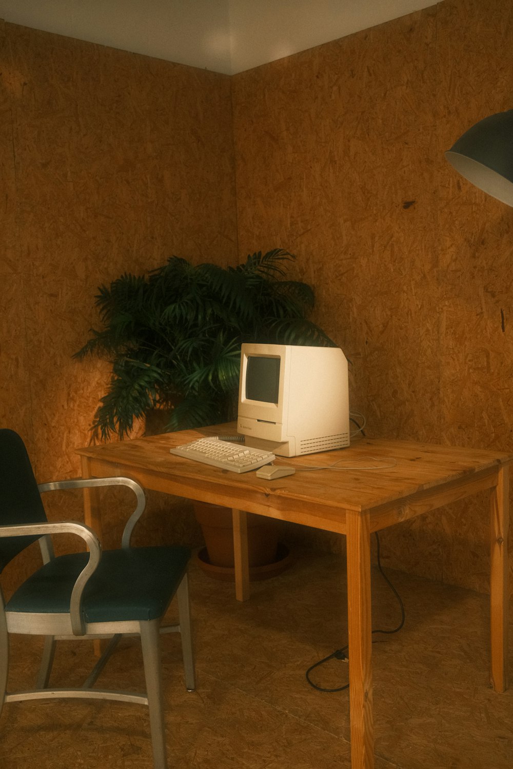 a desk with a computer and a chair