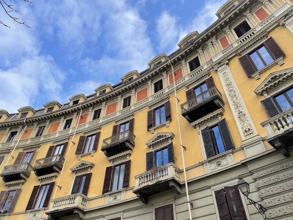 a tall building with many windows and balconies