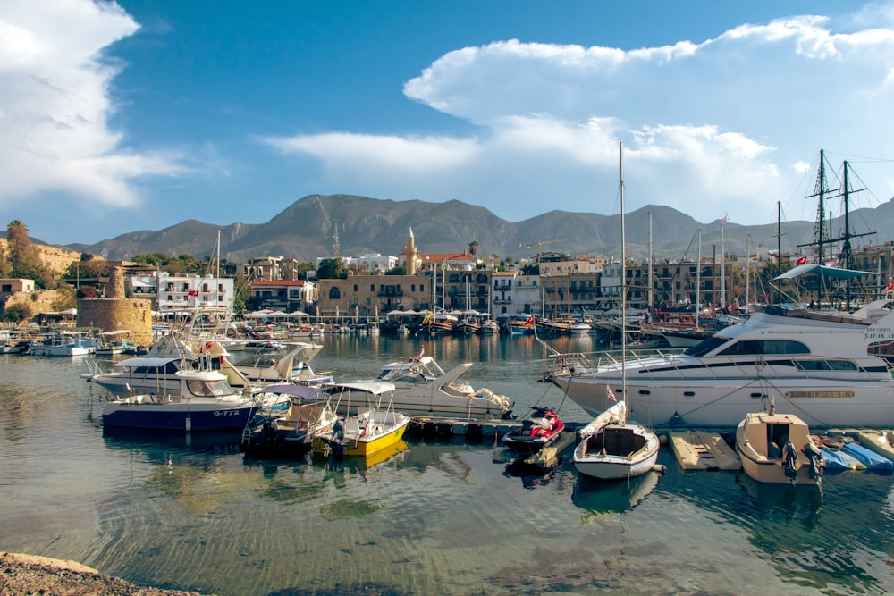 a harbor filled with lots of boats under a cloudy blue sky