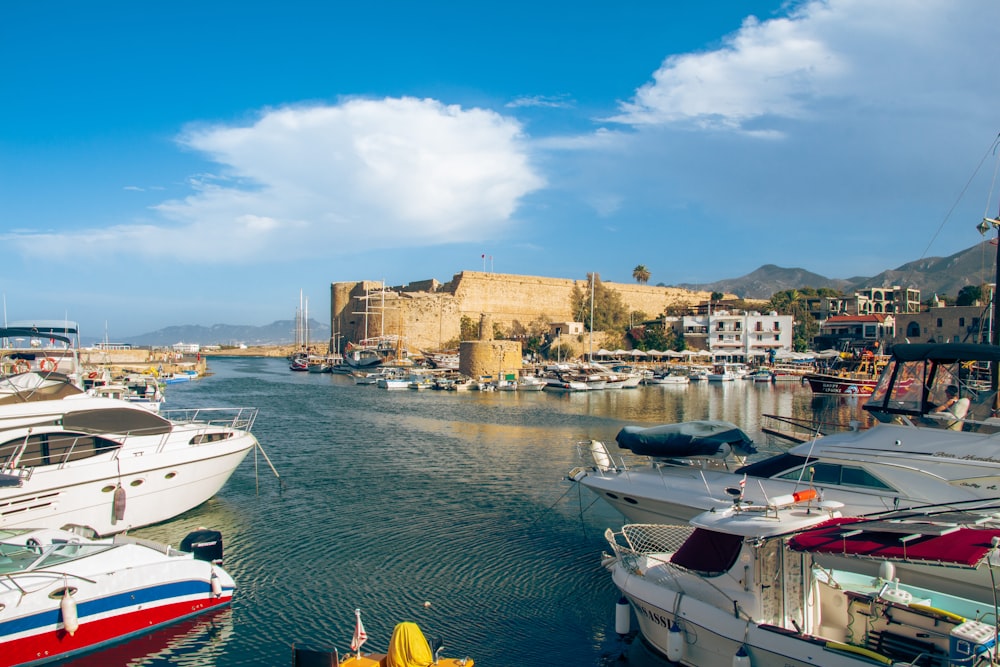 a harbor filled with lots of boats next to a castle