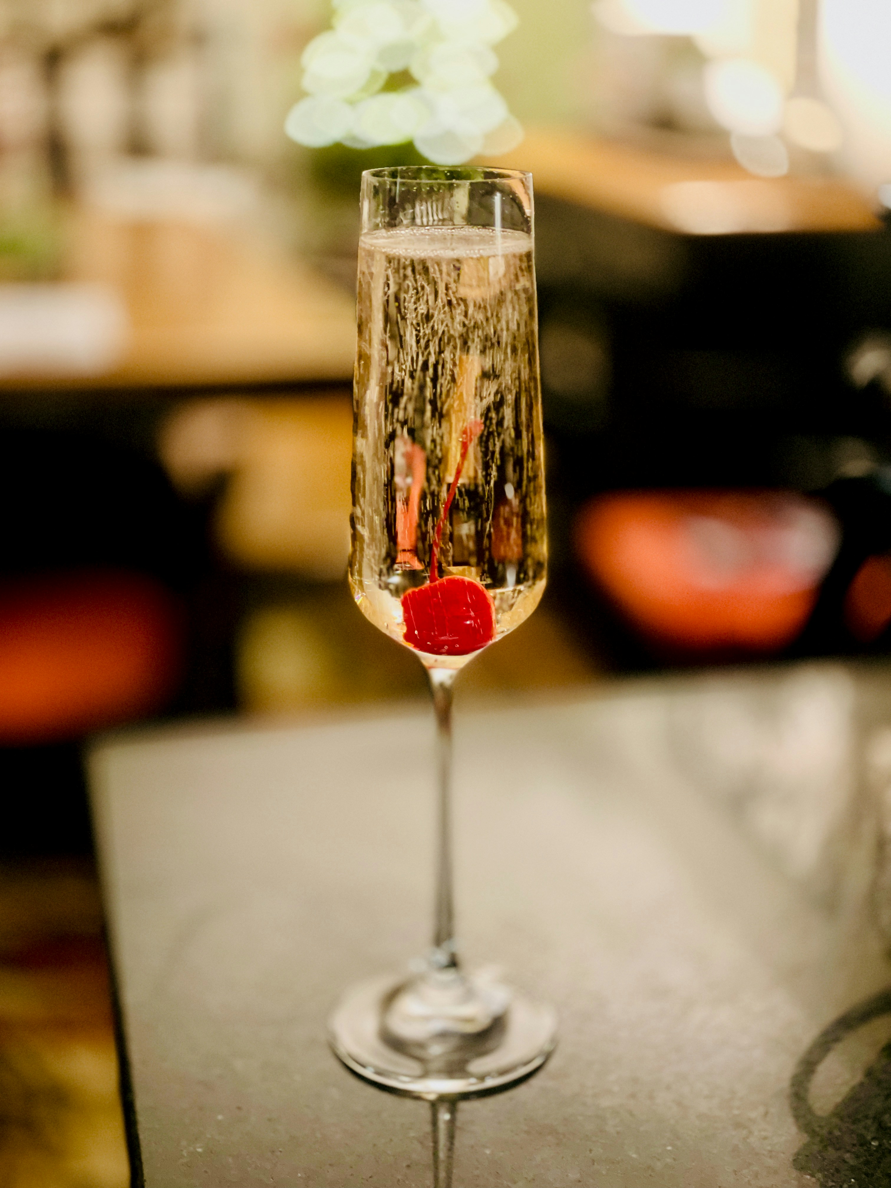 a glass filled with liquid sitting on top of a table