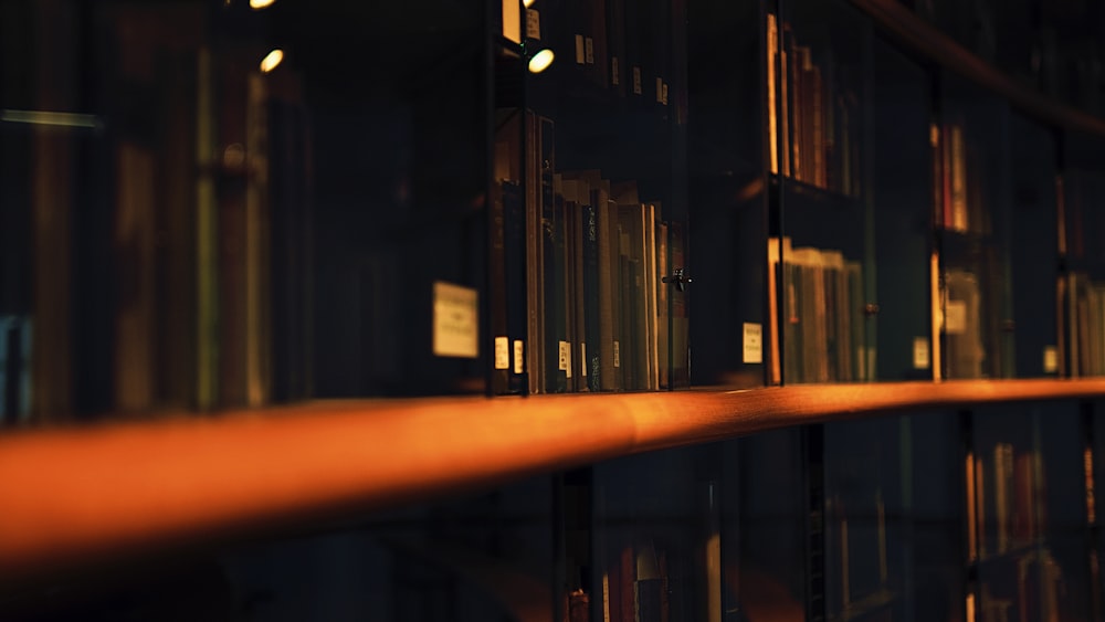 a row of bookshelves in a library at night