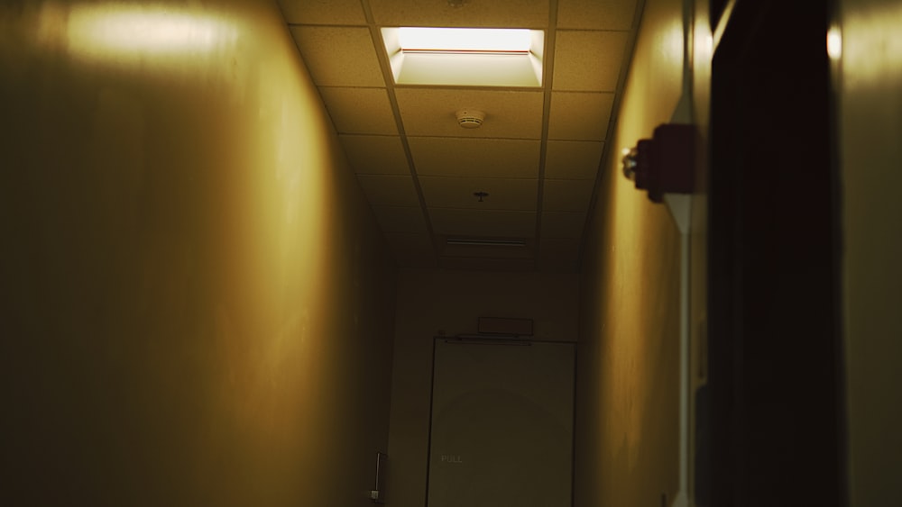 a dimly lit hallway leading to a door