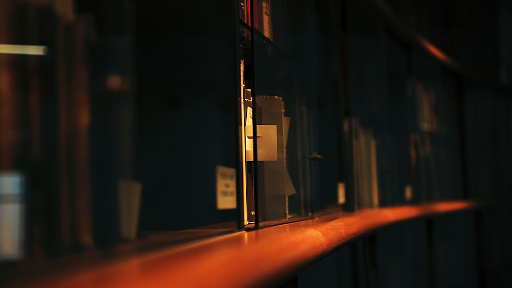 a shelf in a dark room with books on it