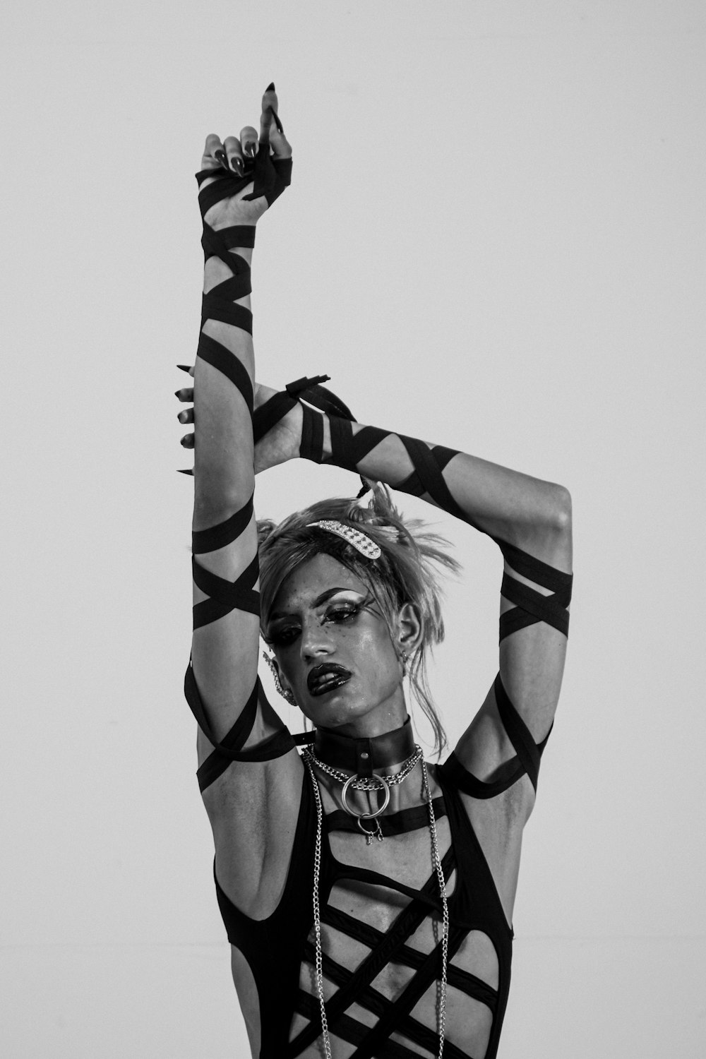 a woman in a black and white photo holding her hands up