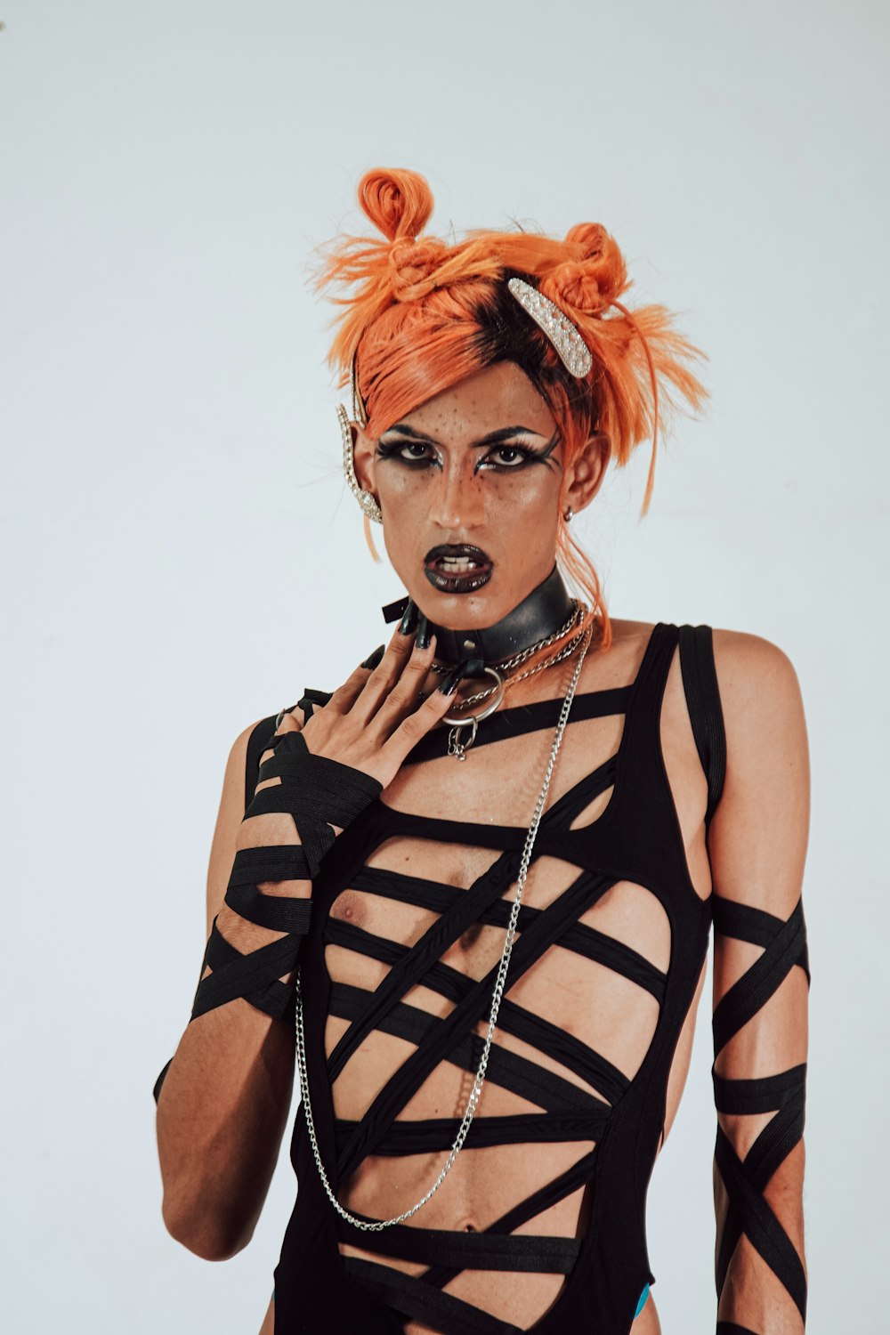 a woman with orange hair wearing a black outfit