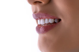 a close up of a woman's mouth with white teeth