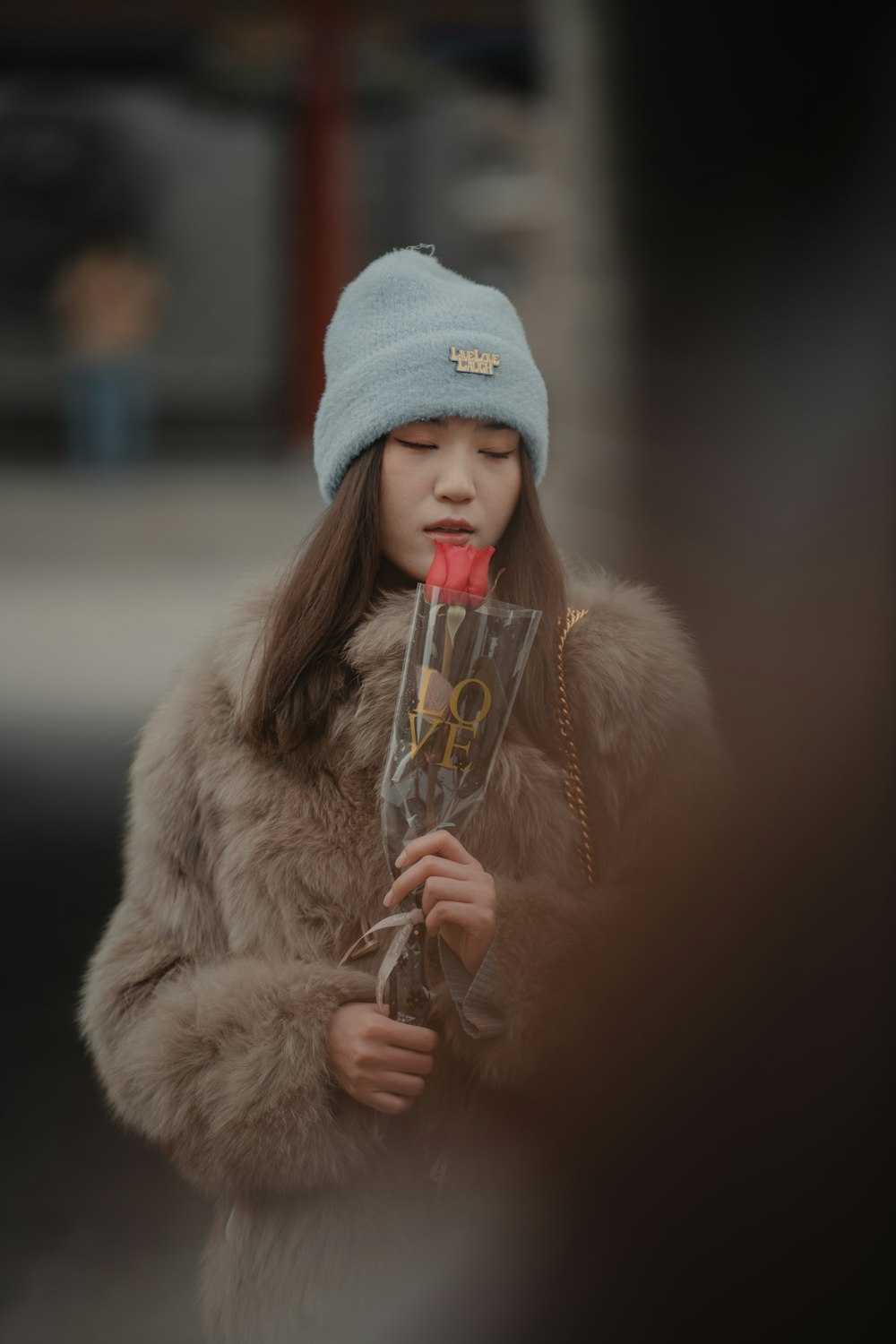 a young girl is holding a bouquet of flowers